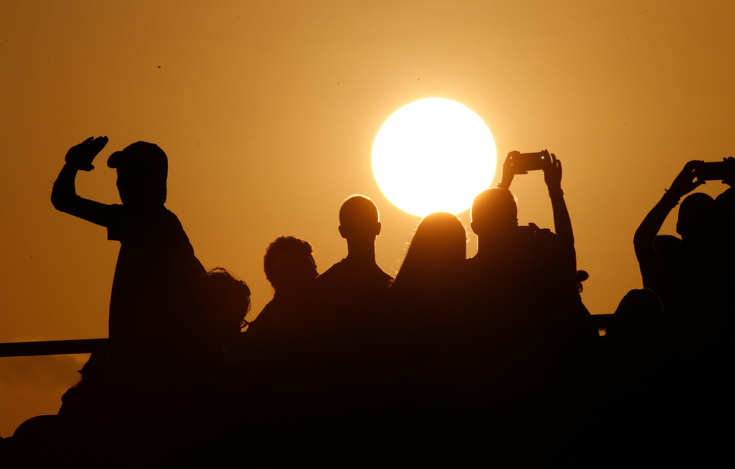 The setting sun is seen during World Youth Day as young people wait for Pope Francis’ arrival at a prayer vigil at St. John Paul II Field in Panama City Jan. 26, 2019.